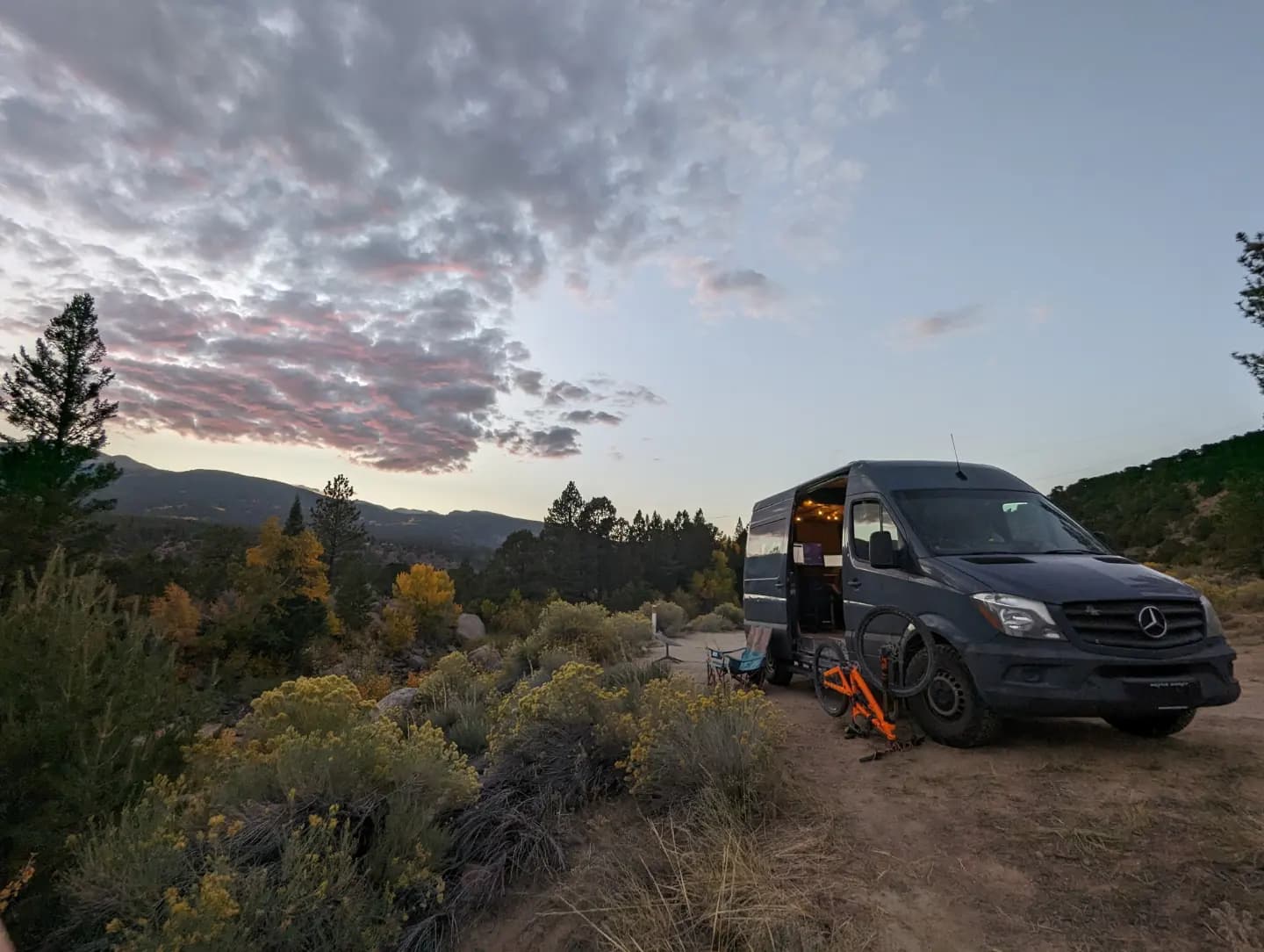 Sean\'s van/mobile office parked in the desert with a mountain in the background